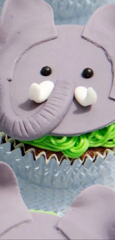 Elephant-themed cupcake on pastel wallpaper background.