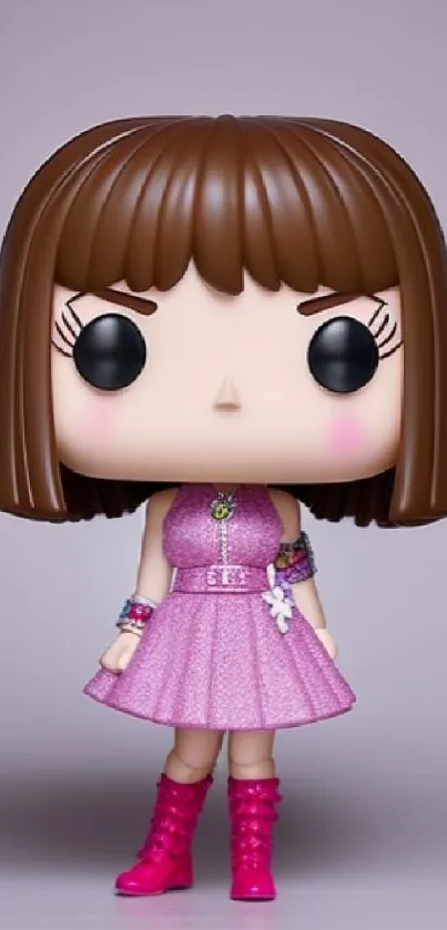 Cute figurine in pink dress with brown hair against a neutral background.