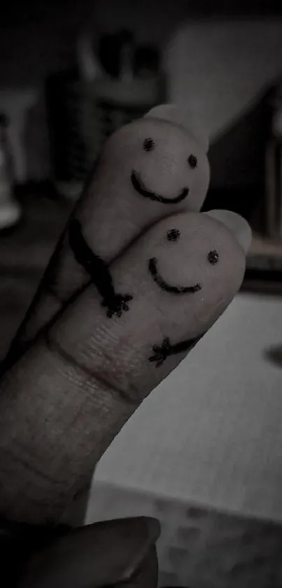 Adorable finger art with smiley faces on two fingers, black and white theme.