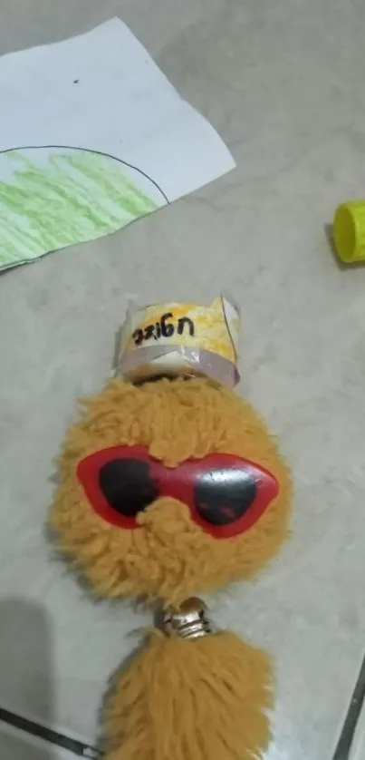 Fluffy toy with red sunglasses and a playful expression.