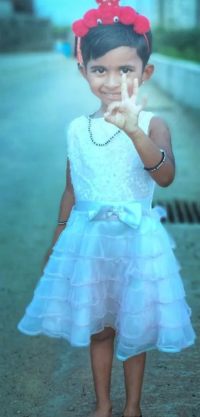 Smiling girl in white dress, outdoor setting.