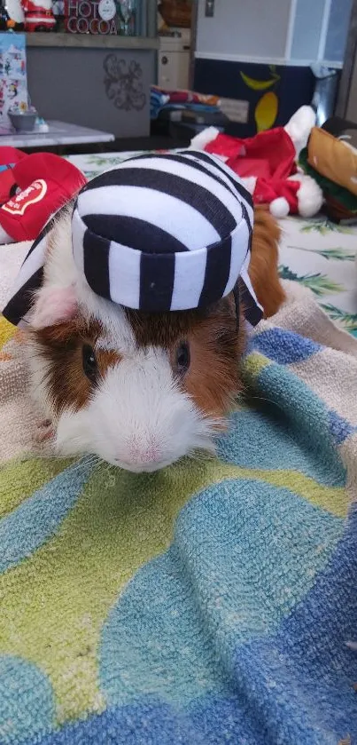 Guinea pig in black striped costume on towel.