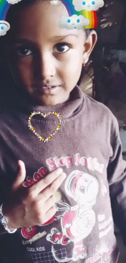 Cute child wearing a brown sweater with rainbow and cloud effects.