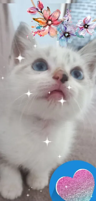 White kitten with a colorful floral crown and blue eyes on a soft backdrop.