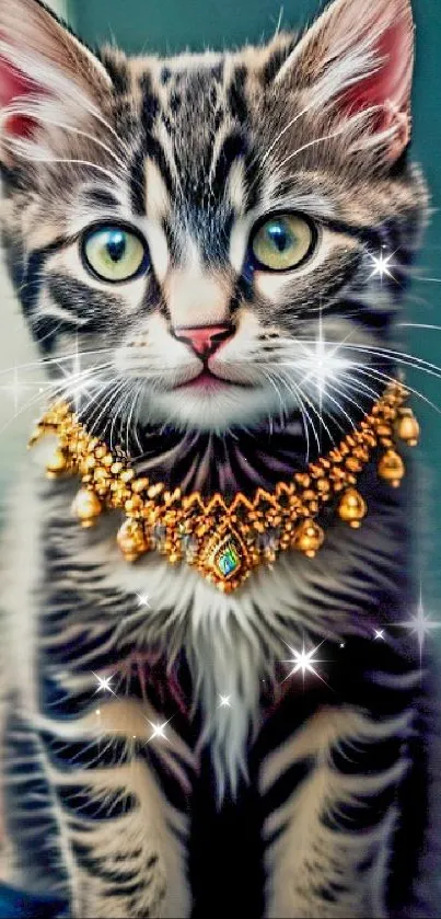 Adorable kitten wearing a gold necklace against a teal background.