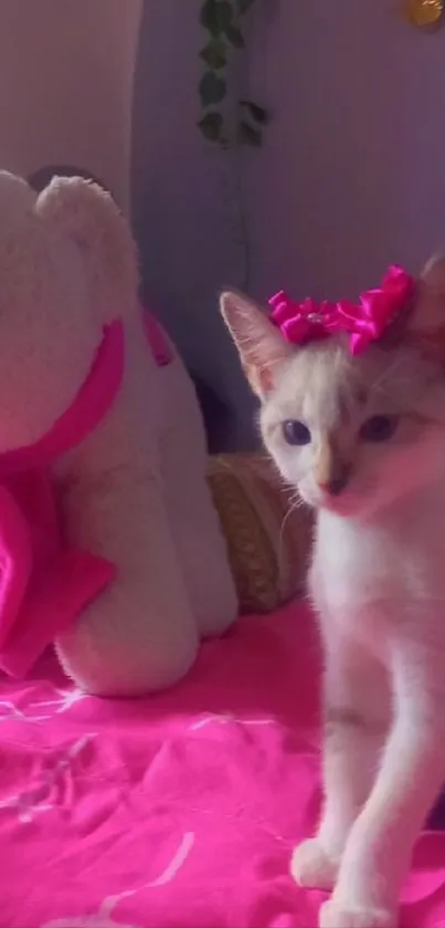 Adorable kitten with pink bow and toy elephant on bed.