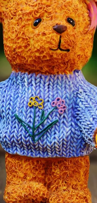 Knitted teddy bear in colorful sweater with floral embroidery.