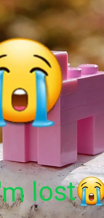 Cute crying emoji and pink block toy wallpaper.