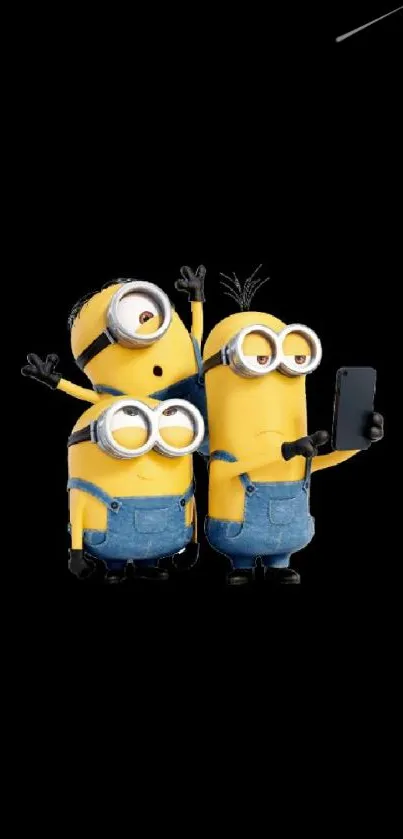 Minions taking a selfie on a black background wallpaper.