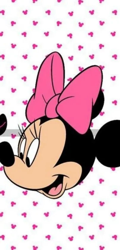 Minnie Mouse with pink bow on polka dot background.