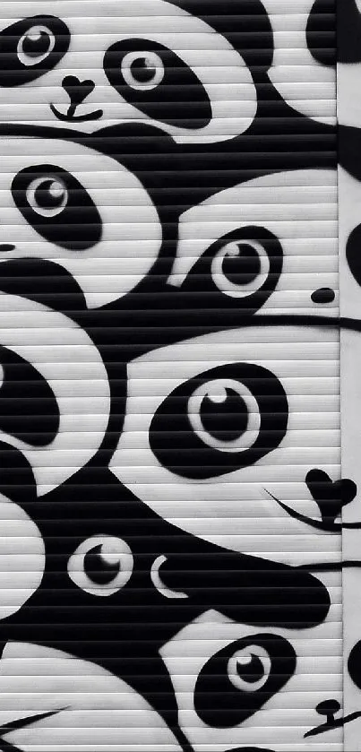 Patterned panda faces in black and white design wallpaper.