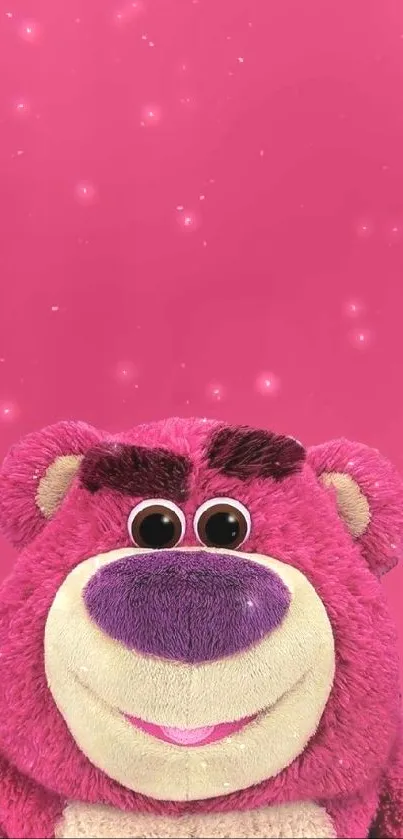 Cute pink bear plush toy against a pink background.