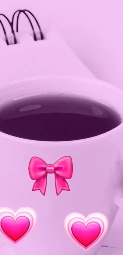 Pink coffee cup with hearts and bow on wallpaper.