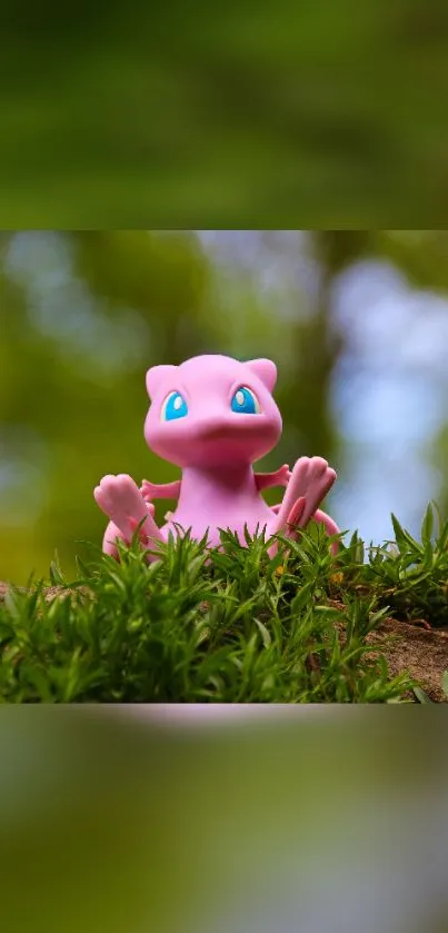 Cute pink creature on green foliage background.