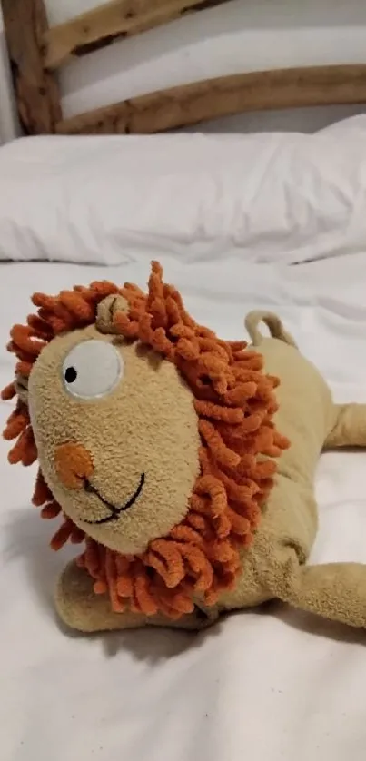 Plush lion toy on a white bed, creating a cozy wallpaper.