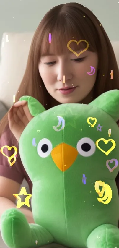 Cute green plush toy with heart shapes on a mobile wallpaper.