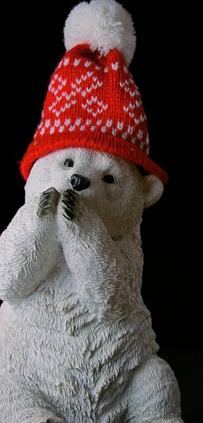 Cute polar bear with a red knitted hat on a dark background.