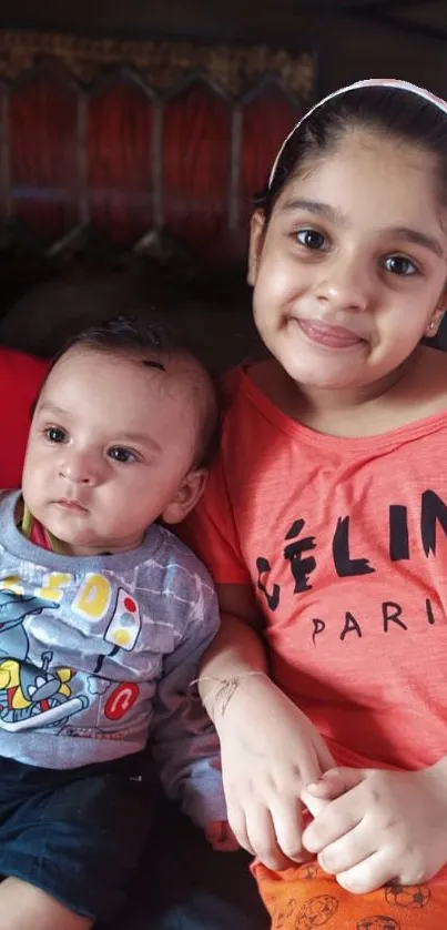 Adorable siblings posing for a mobile wallpaper, showcasing a heartwarming moment.