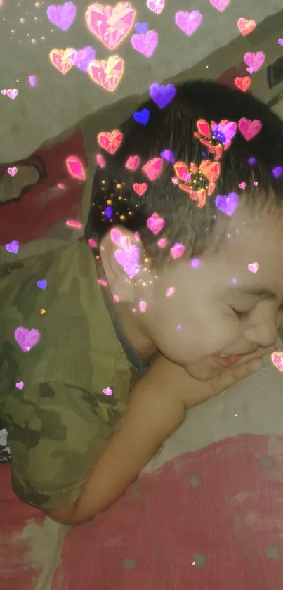 Cute child sleeping with colorful hearts overlay on beige background.