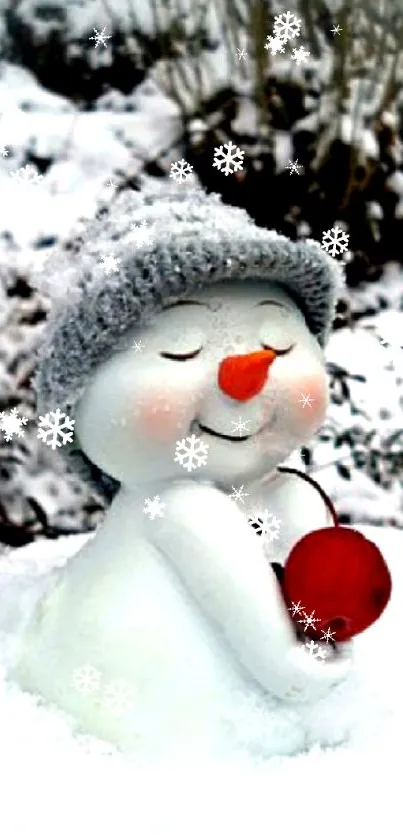 Cute snowman with hat in snowy winter landscape holding a red ball.