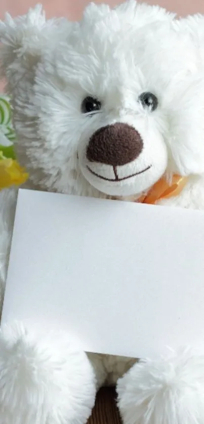 White teddy bear with a blank card, cozy background.