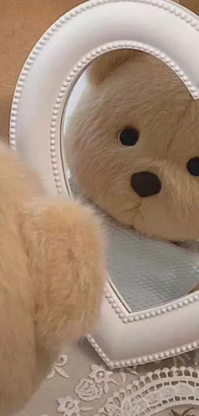 Teddy bear looks into a heart-shaped mirror.