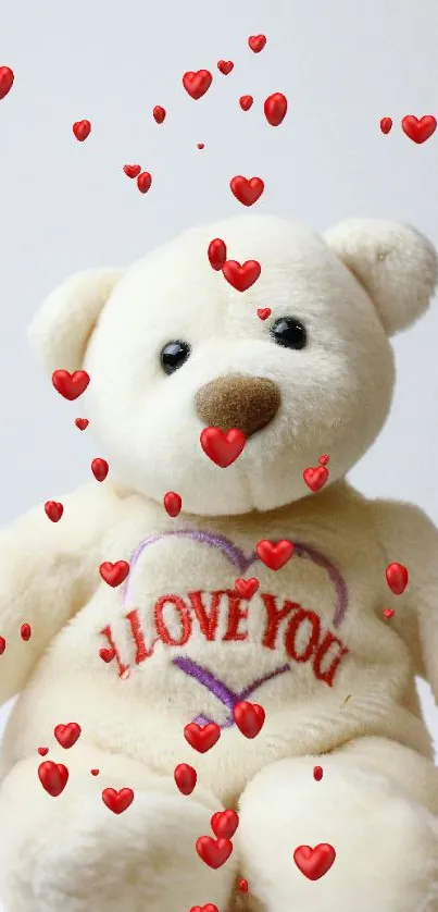 Cream teddy bear with heart design and red floating hearts.