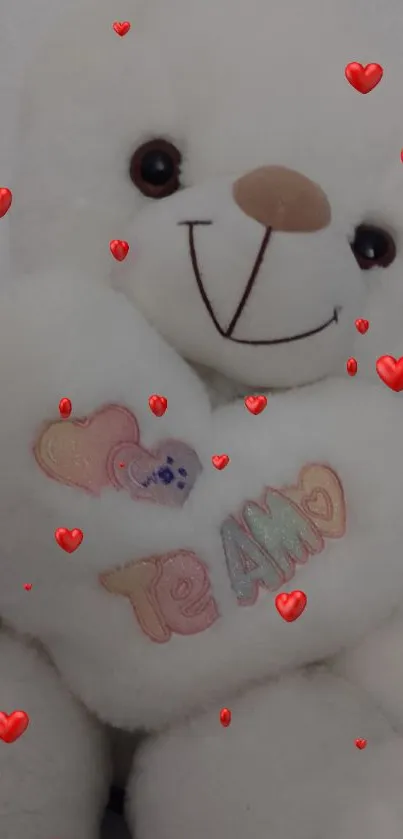 Adorable white teddy bear holding a heart with 'Te Amo' message.