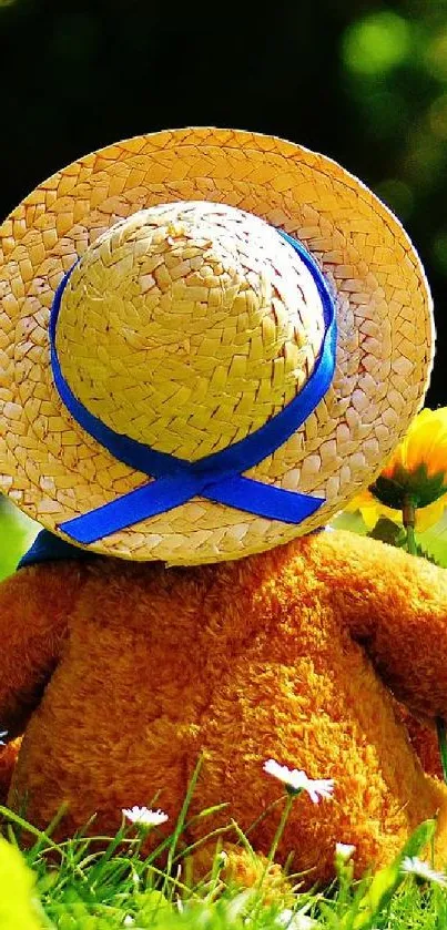 Teddy bear with straw hat in a sunlit green meadow with daisies.