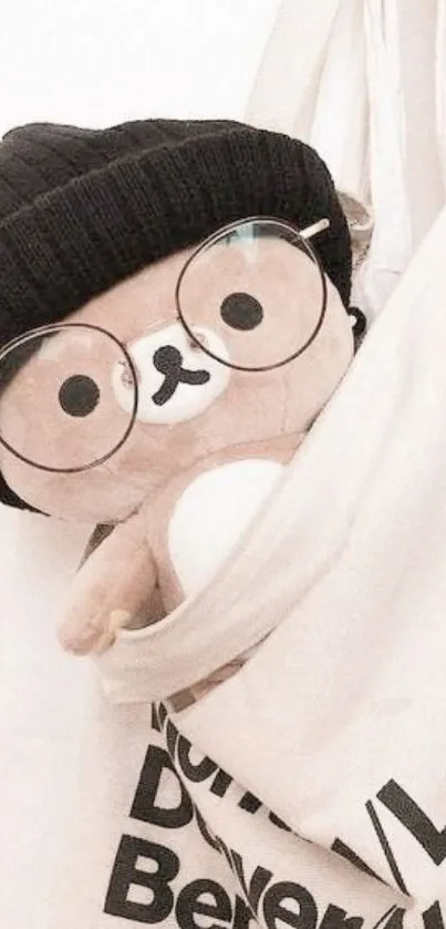 Cute teddy in glasses and beanie peeking from a canvas bag.