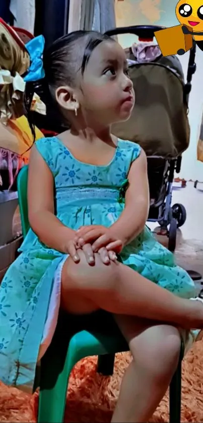 Adorable young girl in blue dress sitting thoughtfully.