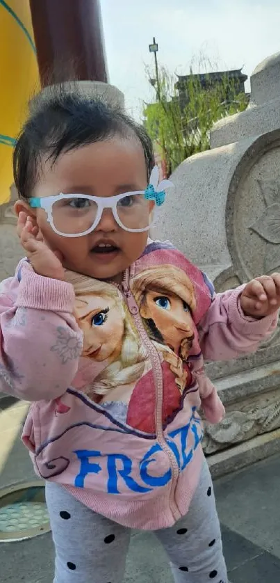 Adorable toddler in colorful clothing outdoors.