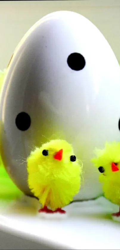 Yellow chicks with polka dot egg against bright background.