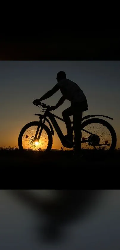 Silhouette of cyclist against a striking sunset on mobile wallpaper.