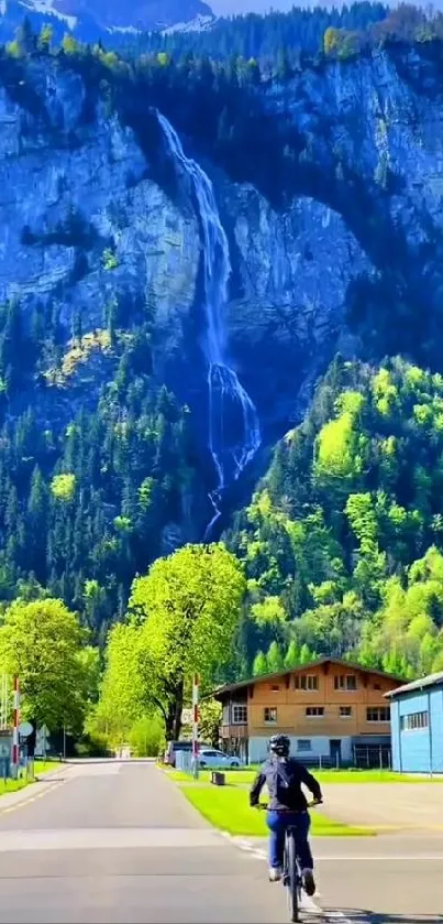 Cyclist on path with mountain waterfall backdrop