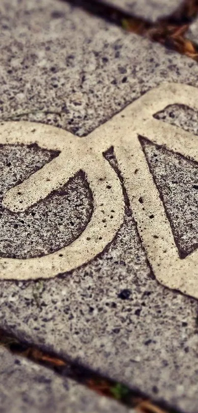 Concrete pavement with cyclist symbol design.