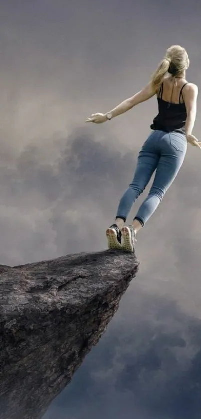 Person standing on cliff's edge under a cloudy sky