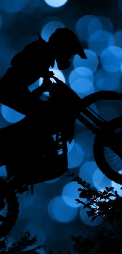 Motorcycle silhouette on blue bokeh background.