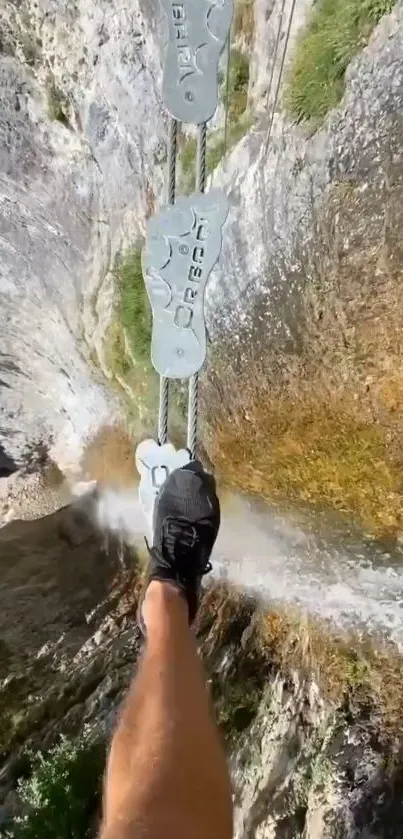 Leg crossing a narrow mountain bridge path.