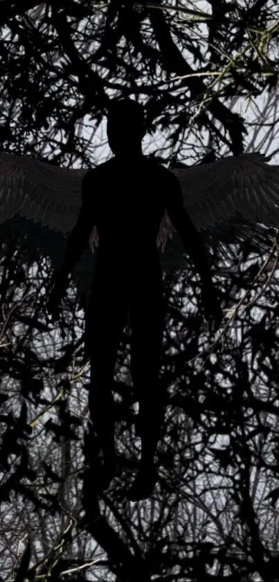 Silhouette of an angel with wings against a dark tangled background.