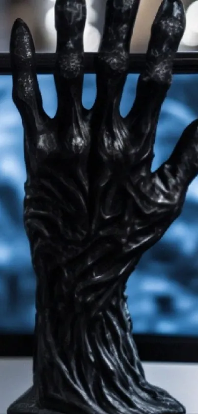 Dark hand sculpture with blue abstract background, artistic phone wallpaper.