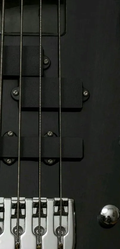 Closeup of dark bass guitar strings on mobile wallpaper.