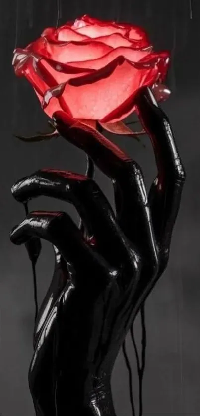 Dark hand holding a glowing red rose.