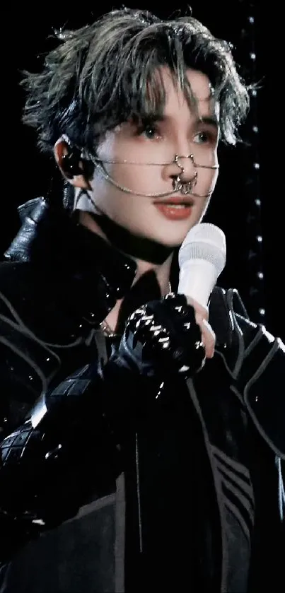 Futuristic performer in black with microphone.