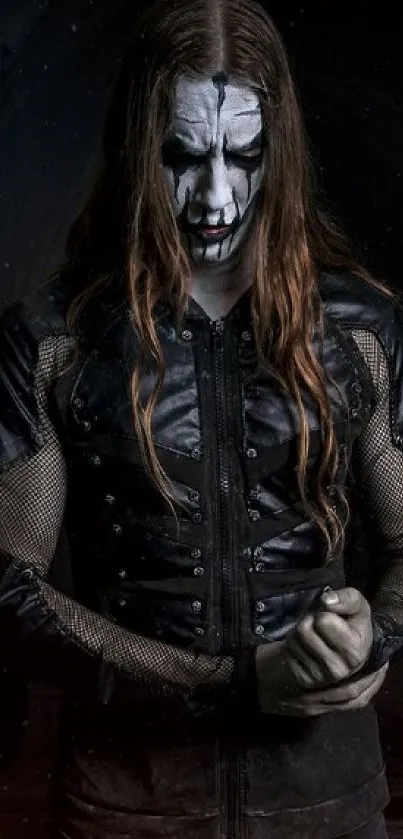 Gothic metal wallpaper with face-painted figure in dark attire.