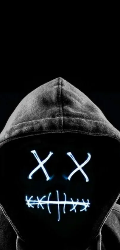 A dark hooded mask with glowing features on a black background.