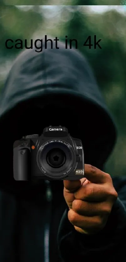 Hooded figure holding camera in forest