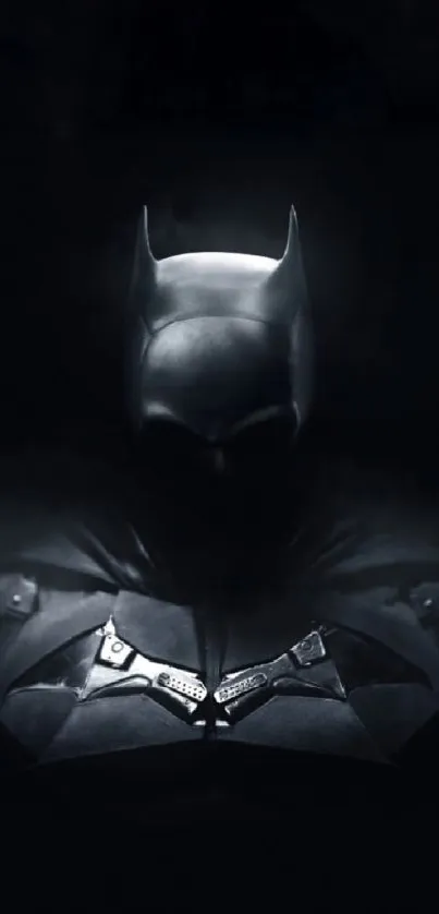 Dark silhouette of Batman on a black background.