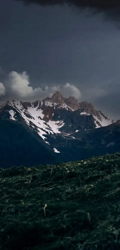 Serene dark mountain nightscape with cloudy sky.