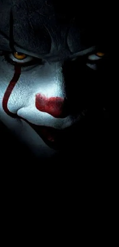 Eerie clown face in dark lighting, creating a mysterious phone wallpaper atmosphere.